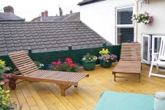 Classic Green gravel boards used around a sun deck.